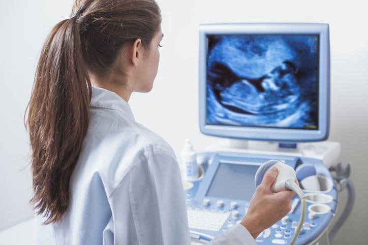 Ultrasound tech in front of machine
